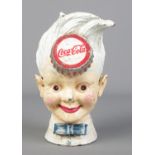 A novelty cast iron Coca Cola money box. Height 20cm.