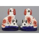 A pair of Victorian Staffordshire spaniels with their pups. Height 20cm. No chips cracks or repairs.