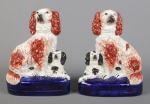 A pair of Victorian Staffordshire spaniels with their pups. Height 20cm. No chips cracks or repairs.