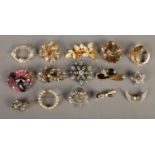 A collection of fifteen vintage brooches, including ceramic floral, winged and bow examples.