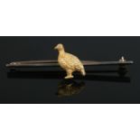 An early twentieth century 9ct gold bar brooch, mounted with 15ct Gold pheasant to the center. Total