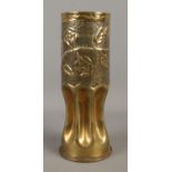 A WWI trench art shell case vase, depicting roses embossed towards the top, and scalloped base.