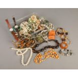 A box of costume jewellery. Includes Pandora style bracelet with some silver mounted charms,
