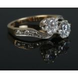 A vintage 9ct Gold two stone cross-over twist ring, with colourless stones. Size MÂ½. Total