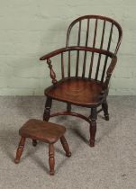 An early Victorian yew wood child's/doll's Windsor chair, featuring crinoline stretcher along with