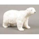 A Beswick figure modelled as a polar bear. Approx. height 12cm. Possible restoration to left side of