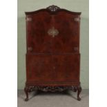 A Queen Anne style burr walnut lockable cocktail cabinet, with fitted interior featuring glass