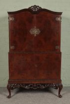 A Queen Anne style burr walnut lockable cocktail cabinet, with fitted interior featuring glass