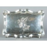 An Edwardian silver dressing table tray with embossed decoration depicting an angel with child.