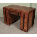 An Art Deco mahogany desk with side storage shelves. (78cm x 114cm x 61cm)