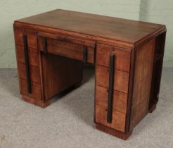 An Art Deco mahogany desk with side storage shelves. (78cm x 114cm x 61cm)
