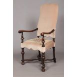 An early 19th century carved walnut upholstered arm chair. Having x-frame stretcher with centre