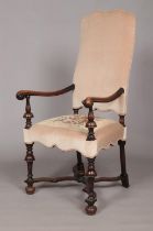 An early 19th century carved walnut upholstered arm chair. Having x-frame stretcher with centre