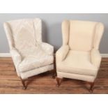 Two upholstered wingback armchairs.