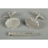 A pair of silver cufflinks along with a silver tie slide. Total weight 10.58g.