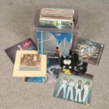 A box of LP records. Includes Rick Wakeman, Status Quo, Paul McCartney etc.