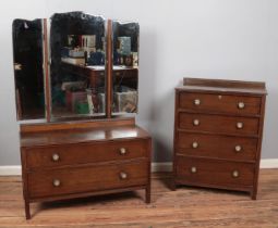 A three-piece oak and ply bedroom suite, comprising of mirrored wardrobe, chest of drawers and