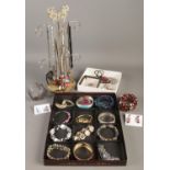 A quantity of costume jewellery. Includes bracelets, necklaces and stand, earrings, etc