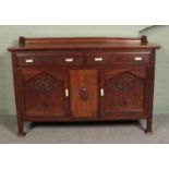 A carved oak sideboard with bakelite handles. Top loose.