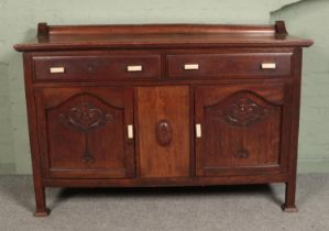 A carved oak sideboard with bakelite handles. Top loose.