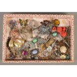 A tray of vintage costume jewellery, mainly brooches and clips.