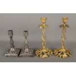 Two pairs of ornately decorated candlesticks to include brass and silver plated examples. Tallest