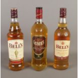 Three bottles of whiskey to include Bell's and Grants blended examples.