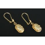 A pair of 18ct Gold Egyptian scarab beetle pendant earrings, with Egyptian standard marks. Test to