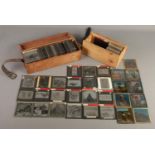 Two cases of magic lantern slides. Includes Holy War, Jack and the Beanstalk, buildings, military