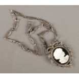 A silver and marcasite necklace, the pendant having mother of pearl silhouette of a maiden.