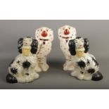 Two pairs of Staffordshire mantel dogs including pair carrying flower baskets. Tallest example