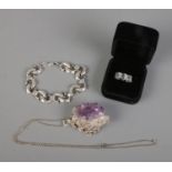 A collection of silver jewellery to include dolphin bracelet, amethyst crystal pendant on chain