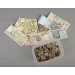 A quantity of mixed coins and bank notes from around the world.