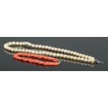 A cultured pearl necklace on silver clasp, together with a twisted three strand coral bracelet on