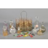 A collection of mainly decorative glassware, to include gold etched glasses in stand, scent