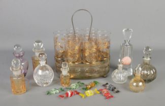 A collection of mainly decorative glassware, to include gold etched glasses in stand, scent