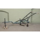 An antique iron two handle plough. Approximate length 240cm.
