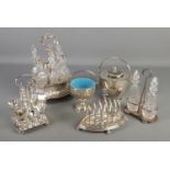 A collection of silver plated items. Includes six bottle cruet set, seven bar toast rack, Mappin &