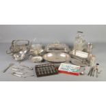 A collection of silver plated items, to include four piece cruet set, wine bottle holder, lidded