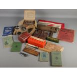 A box of WWII collectables. Includes gas masks, United Kingdom flag, Dominoes, books, etc.
