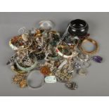 A quantity of costume jewellery including bracelets, necklaces and brooches.