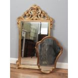 An ornate gilt framed bevel edge wall mirror along with a smaller example. Largest 100cm x 57cm.