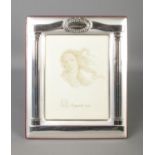 A silver photo frame, with easel back and Greek style Corinthian pillar decoration. Stamped lower