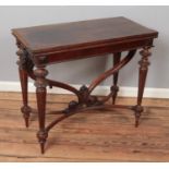 A carved mahogany fold over tea table. Raised on scrolled support and reeded tapering legs. (78cm
