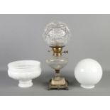 A decorative glass bodied oil lamp (converted to electric), raised on stepped base, together with