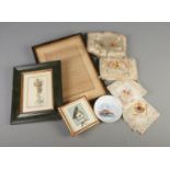 A selection of embroided French souvenir handkerchiefs and pin cushions along with a framed French