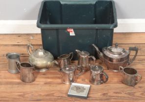 A box of metalwares. Includes teapots, jugs, sugar bowls, etc.