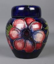 A small Moorcroft pottery dark blue ground ginger jar with cover in the 'Anemone' design. With