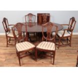 A mahogany twin pedestal extending dining table, with additional leaf and six wheat back dining