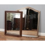 Two framed bevel edge wall mirrors. One with mahogany frame, the other gilt.